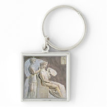 Relief depicting a woman at her toile keychain