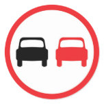 Round sticker with no overtaking traffic sign.