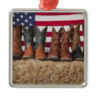 Row of cowboy boots on haystack Christmas ornament
