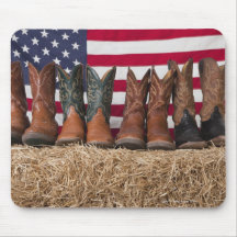 Row of cowboy boots on haystack mouse pads