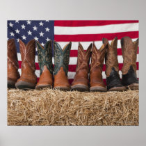 Row of cowboy boots on haystack posters