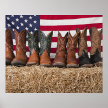 Row of cowboy boots on haystack posters