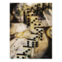 Row of dominoes on old world map post cards