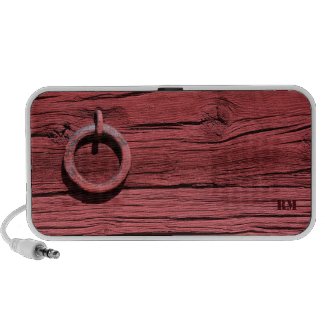 A Doodle portable Mp3 speaker for laptops with weathered red wood and iron ring effect on the speaker fabric