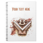 Rusty old chrome V8 badge from a classic car notebooks
