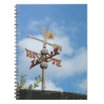 Rusty Weathervane against blue sky Notebook