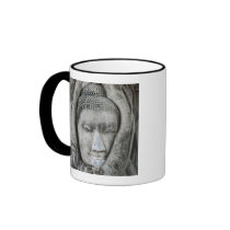 Sandstone head of Buddha surrounded by tree Mug