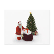 Santa setting presents by the tree postcards