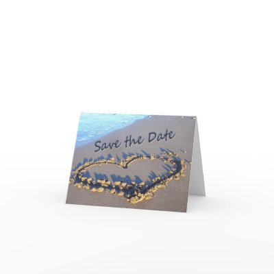 Save the Date cards, with a heart drawn in the sand.