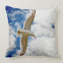 Seagul in flight with blue skies and white cloud, throw pillow