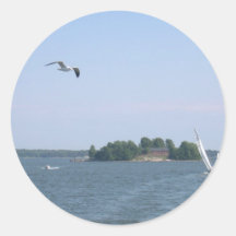 Seagull Flying Near The Island And Yacht At Helsin Round Stickers