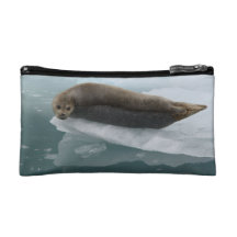 seal resting on ice cosmetics bags