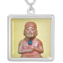 Seated figure, possibly one  earliest pendants