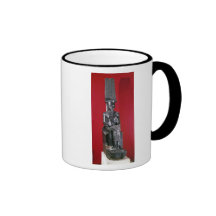 Seated statue of god Amon protecting Mugs