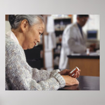 Senior woman in pharmacy reading medicine bottle posters