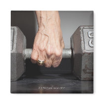 Senior woman lifting weights magnet