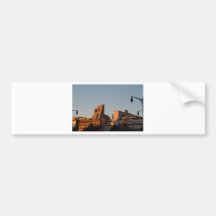 Setting sun illuminates old NYC Bumper Sticker