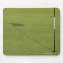 shadow of golf flag on golf course green mouse pads