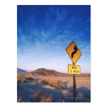 Sign on the death valley road in sunset post cards