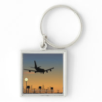 Silhouette of an airplane in flight key chains