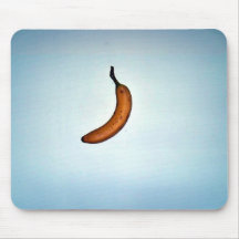 Single whole unpeeled banana mousepads