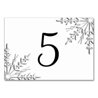 This table card features intricate silver tone snowflakes adorning the corners with a white background, perfect for a winter wedding reception or party