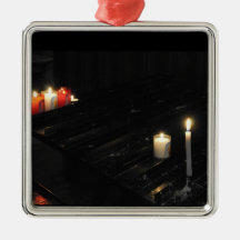 Some religious candles on a black support christmas ornaments