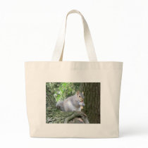 Squirrel eating a monkey nut tote bag