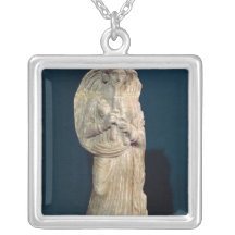Statuette of a woman playing a double flute pendant