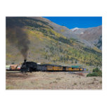 Steam train leaving town postcard
