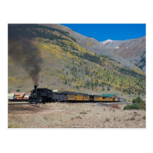 Steam train leaving town postcard