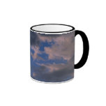 Storm clouds against blue sky coffee mug