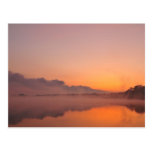 Stormfront coming, orange sunrise at lake post card