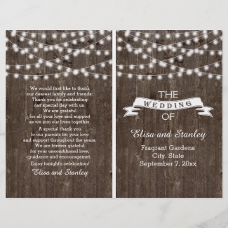 String lights on old wood folded wedding program