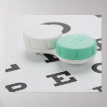 Studio shot of contact lens case on eye chart poster