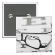 Studio shot of eyeglasses on eye chart button