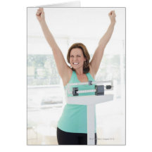 Successful weight loss. Happy woman weighing Greeting Cards