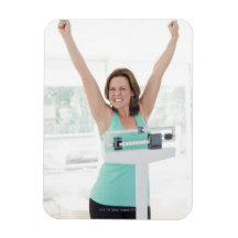 Successful weight loss. Happy woman weighing Flexible Magnet