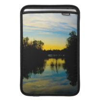 Sunset over a Lake MacBook Sleeves