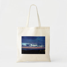 The last red glow of the sun tote bags