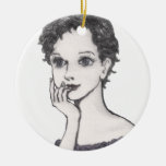 The woman rests her cheek on her hand christmas ornaments