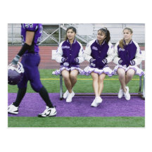 Three female cheerleaders (16-18) watching post card