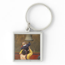 Tibetan Buddhist monk lifting a boy to ring a Key Chains