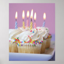 Tray of birthday cupcakes with candles posters