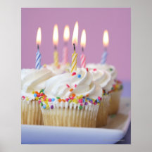 Tray of birthday cupcakes with candles posters