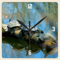 turtles sunning on a log wall clock wall clocks
