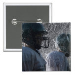 Two American football players in rain, side view Pin