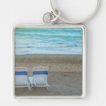 Two chairs on beach sand ocean waves key chain