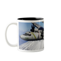 Two E-2C Hawkeyes conduct a flyby Mugs