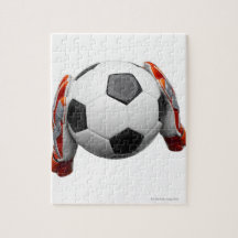 Two goal keepers gloves holding a football puzzle